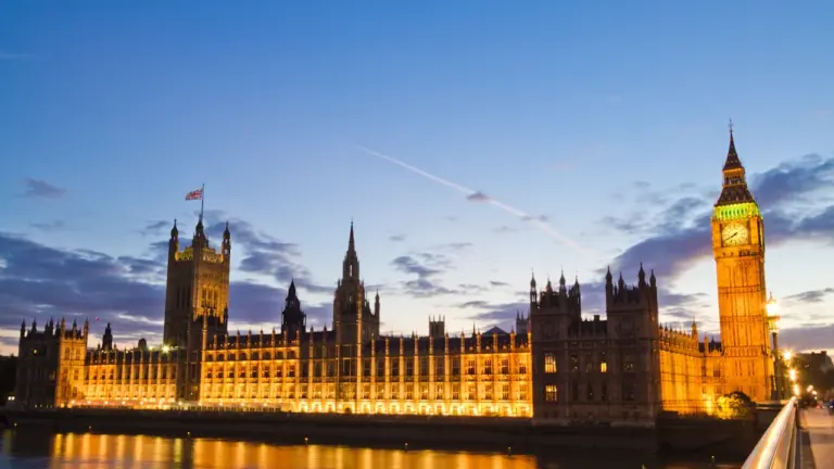 Big Ben and the Palace of Westminster illuminated at dusk in London.