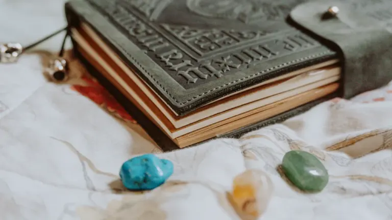 A vintage journal with crystals on a floral fabric background in London.