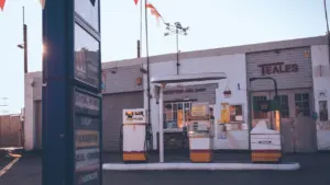 Vintage style petrol pumps standing in front of a local garage facility in Leeds.