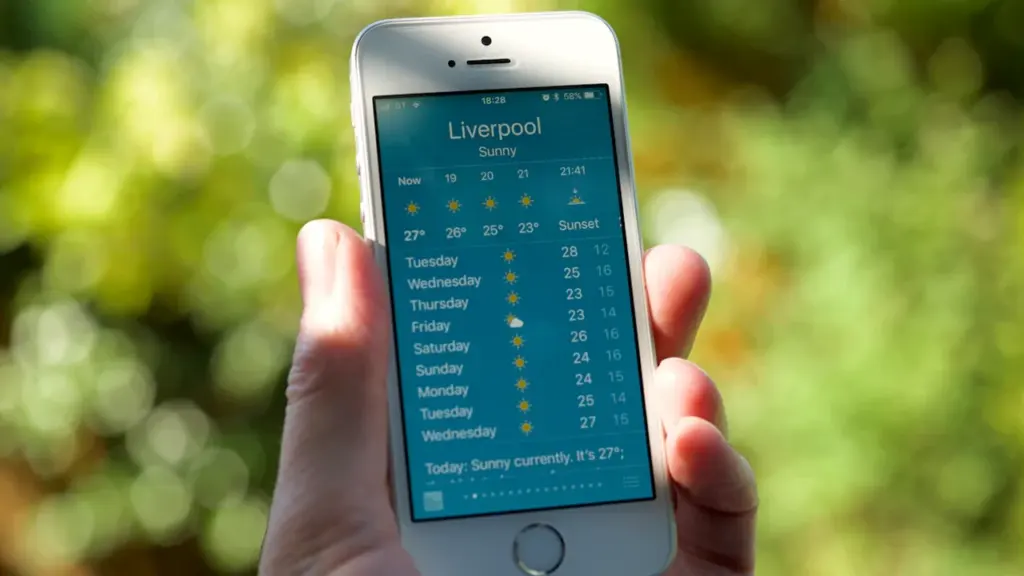 Close up of a smartphone screen showing a sunny weather forecast for Liverpool, UK.